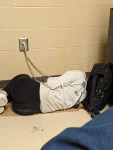 Skinny college teen wearing leggigns curled up on the floor