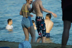 Hot Girl in Swimsuit Top and Denim Shorts by the Water on the Beach Creepshots