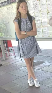 Cute girl wearing a dress at the train station