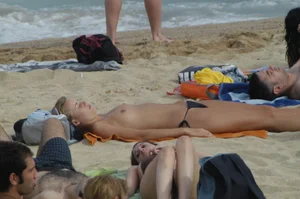 Topless girls on a beach in Barcelona