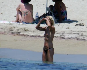 Small boobed topless milf on the beach