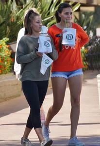 Brunette in tiny shorts walking with her sexy friend in leggings