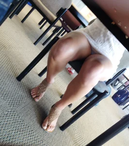 Sexy brunette upskirted showing her blue panties under the table