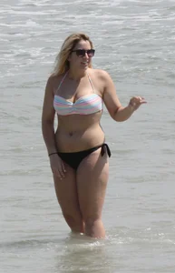 Big boobed thick blonde on the beach in a bikini