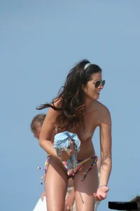 2 topless girls at the beach in thongs