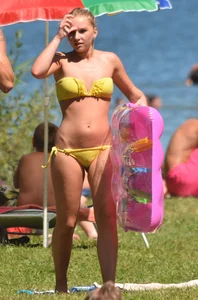 Blonde looking sexy in a yellow bikin
