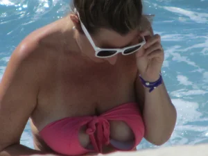Mature milf's tits flashing in the pool