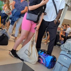 Hot airport girl wearing pink tight short