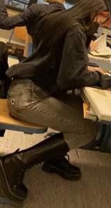Hot Girl in a Mask, Jeans And Knee-High Boots Sitting in the College Class