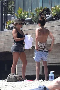 Ashley Tisdale in cheetah print swimsuit on the beach in Malibu