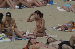 Topless girls on a beach in Barcelona