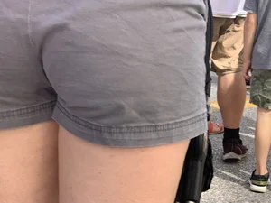 Bunch of girls in various outfits at a Cardinals baseball game