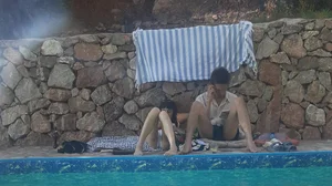 Very skinny girl by the pool