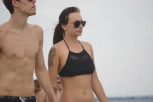 Peach bikini tattood babe on the beach with a nice ass and some camel toe