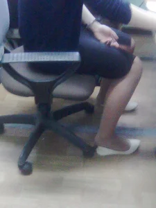 Girl in a Skirt in the Office Chair Candid Photos