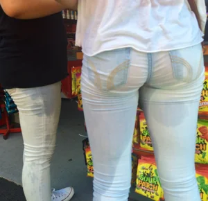 Girl in wet jeans making them semi see through