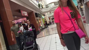 Little blonde teen in grey leggings at the mall with her friends
