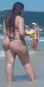 Fat ass milf at the beach in a thong bikini