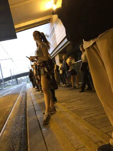 Cute Teen in Shorts on the Tram Stop