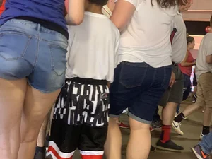 Bunch of girls in various outfits at a Cardinals baseball game