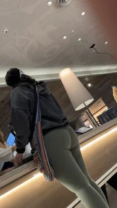 Sexy bubble butt in tight green leggings at the mall