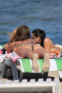 A couple sexy girls laying out on the beach