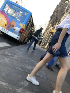 Candid girl wearing denim shorts crossing the street, sexy slim legs