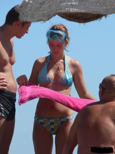 A bunch of hot babes on the beach in thong bikinis
