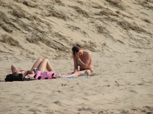 Topless beach girl with nice titties with her friend in a bikini