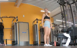 Gym brunette in tight grey shorts