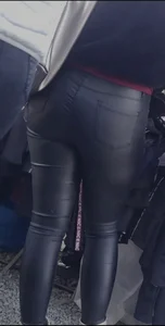 Milf shows off her shapely ass in her leather pants at the market