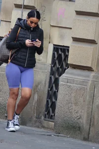 Wide hipped, juicy fronted tanned brunette pawg struts in lycra shorts