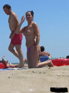 Purple thong topless lady on the beach gets oiled up by her husband