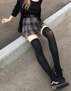 A Skinny Candid Girl in a Skirt And Black Stockings Sitting on a Street Curb