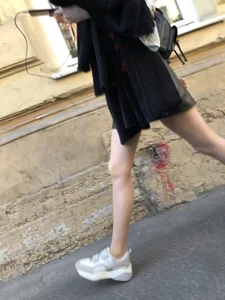 Nice slim legs of a candid girl wearing a leather skirt