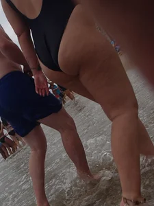 Thick blonde on the beach with a big booty in a blue swimsuit