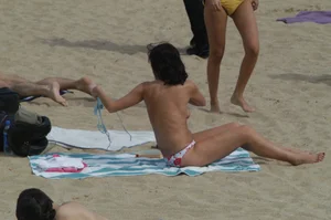 Topless girls on a beach in Barcelona