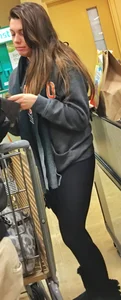 Fit shopping brunette girl in leggings and a hoodie with a nice ass