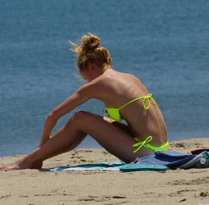 Sexy ass blonde milf on the beach in a thong with cameltoe and bending over