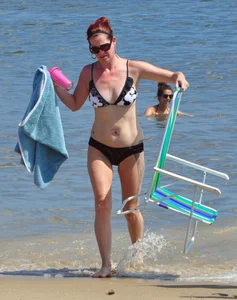 Tattooed redhead milf in a bikini at the beach