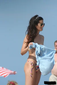 2 topless girls at the beach in thongs
