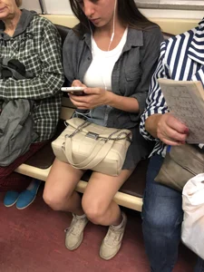 Very hot candid girl sitting in a subway train, closeups of her legs
