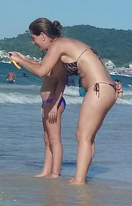 Milf on the beach in a thong bikini