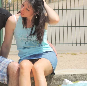 Brunette sitting upskirted showing her white lace panties