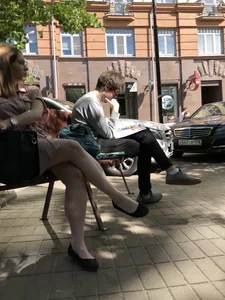 Girl With Stocky Crossed Legs in Flats at a City Square