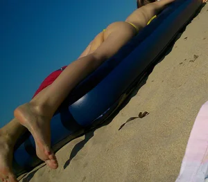 Girl in Swimsuit Lying on an Inflatable Mattress - Feet Closeup Candid on a Beach