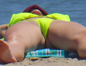 Sexy ass blonde milf on the beach in a thong with cameltoe and bending over