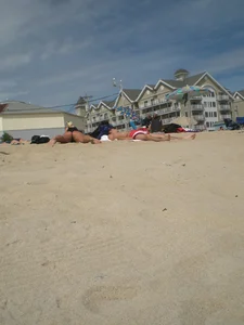 Milf laying out on a beach in Maine in her little thong