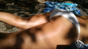 Sexy bikini ass laying out on the rocks up close