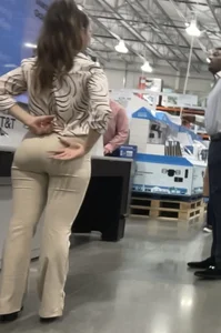 Plus Face shot - Gorgeous AT&T babe in beige pants  touching her ass with long red nails